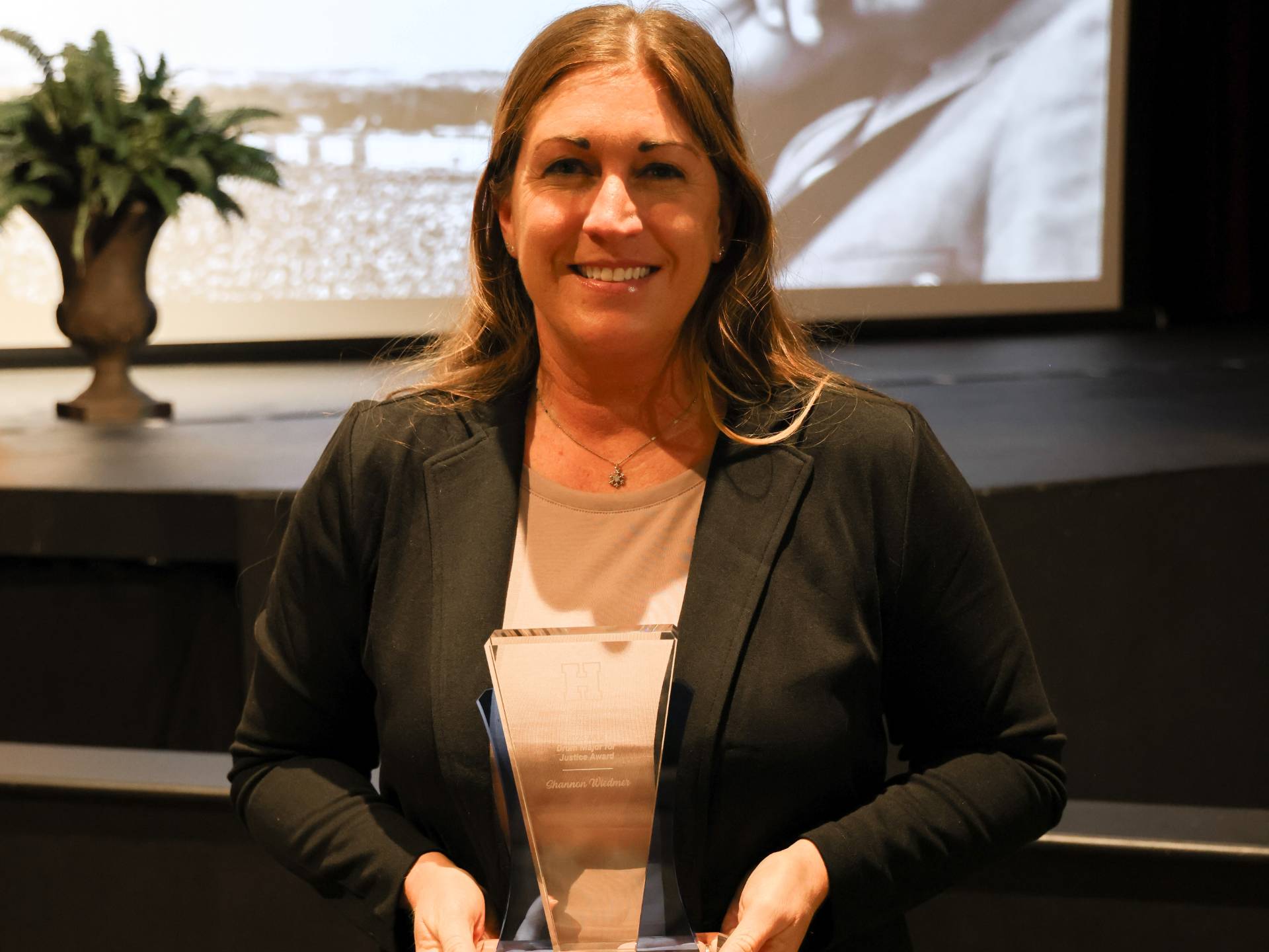 Shannon holds her employee award for the MLK Drum Major Award