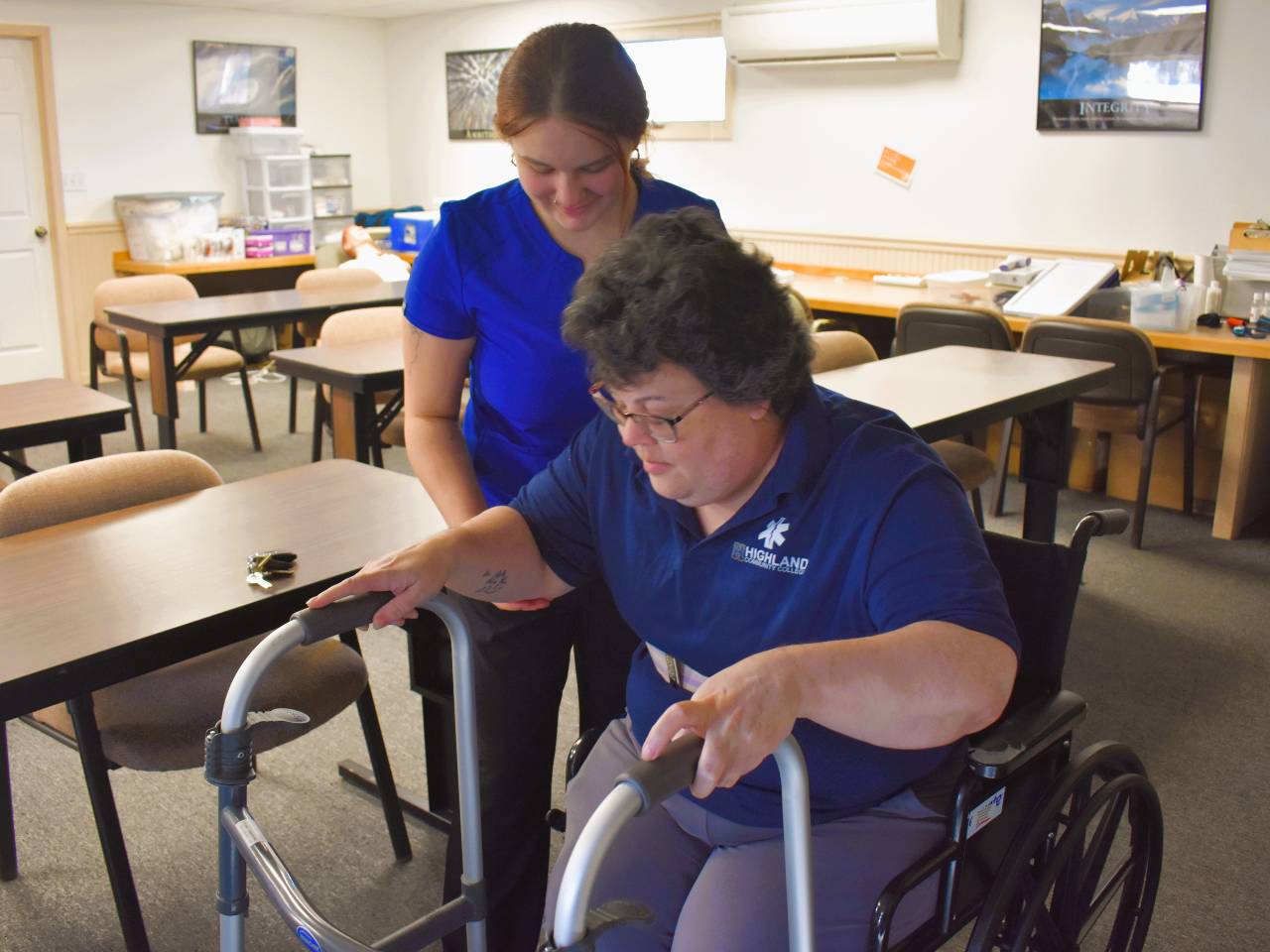 Student is helping a patient move from wheelchair to walker.