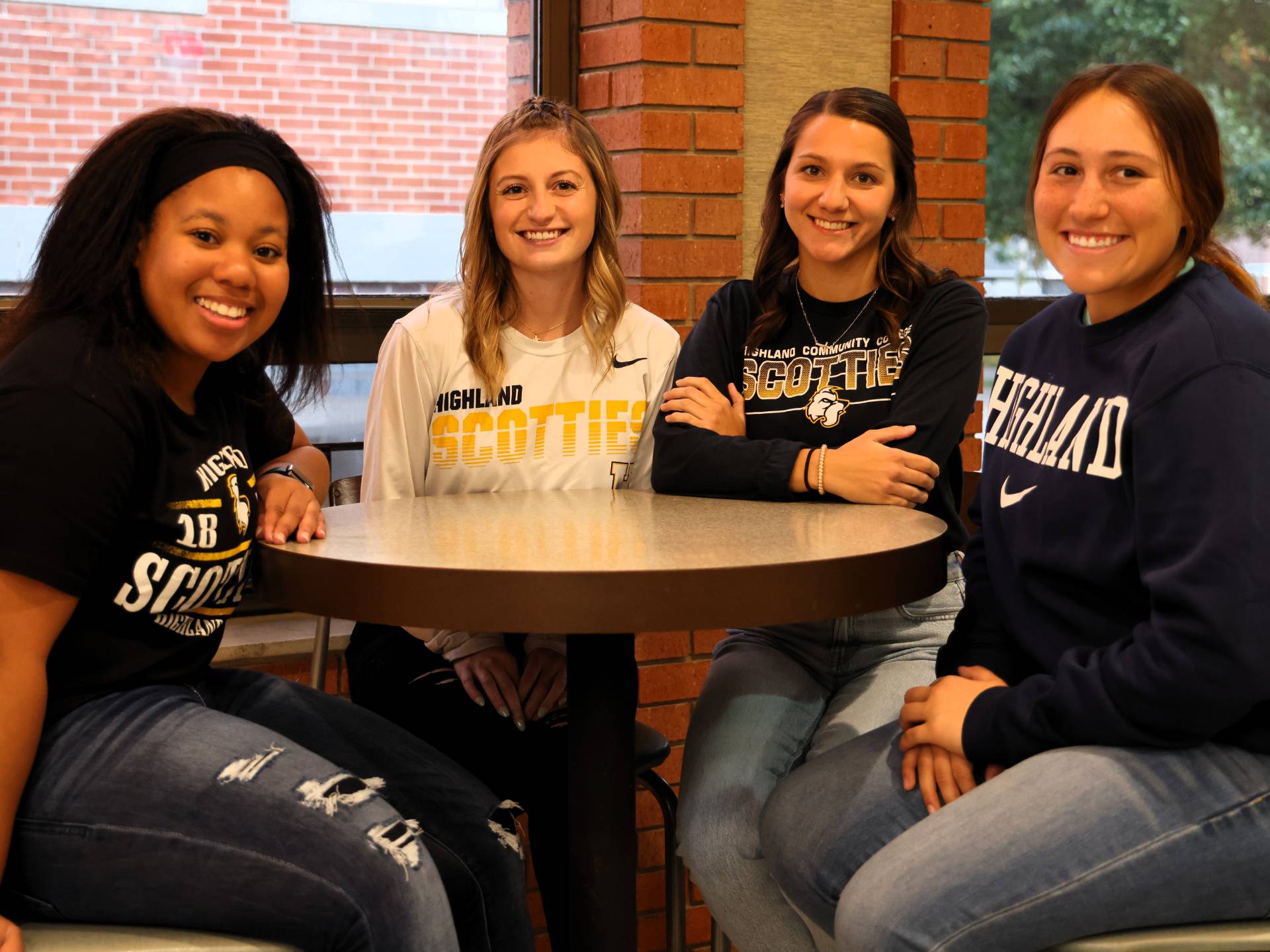 Four Students Sitting a Table, posing for the camera