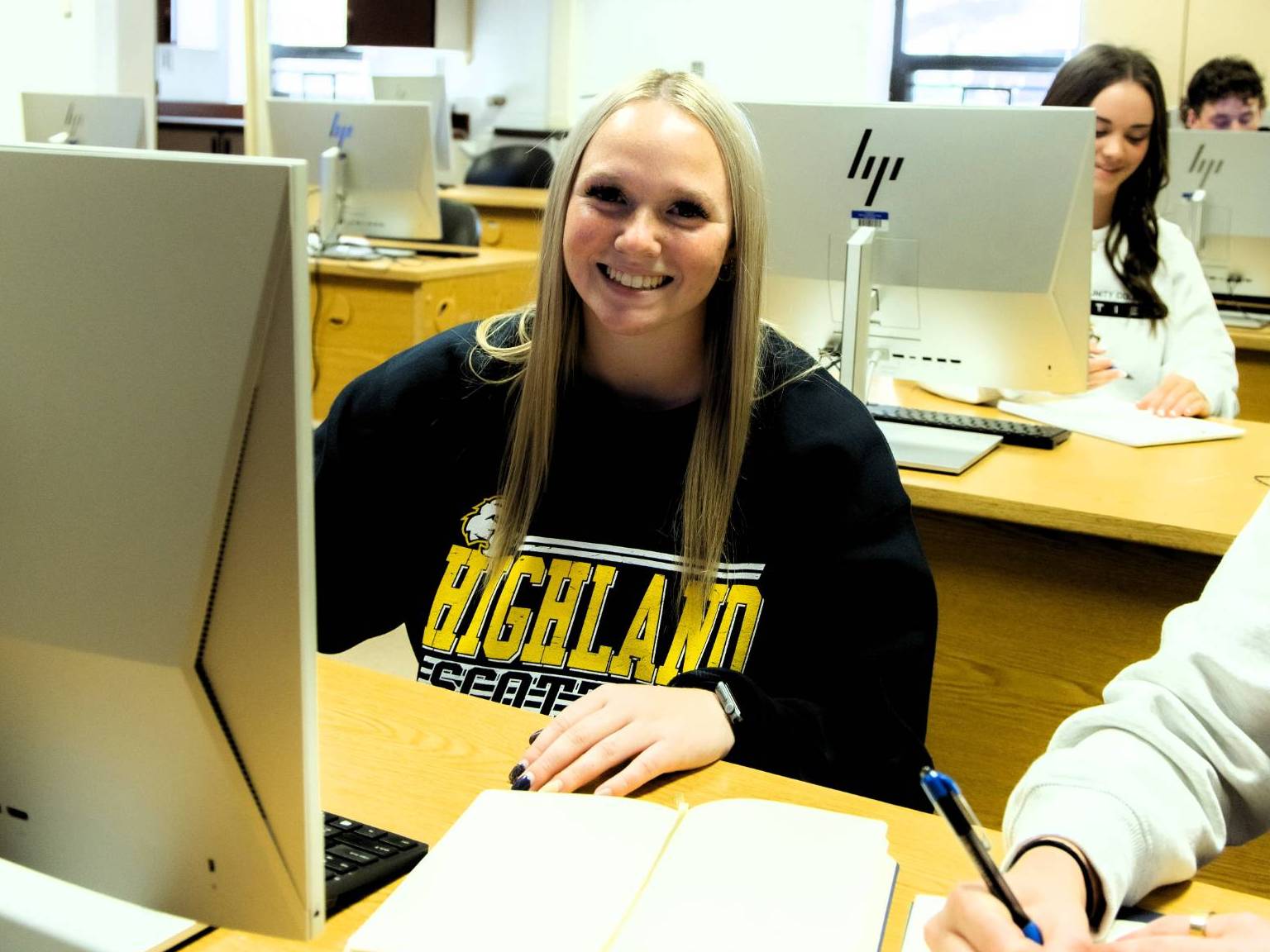 Group of students in a lab with one student facing the camera. 