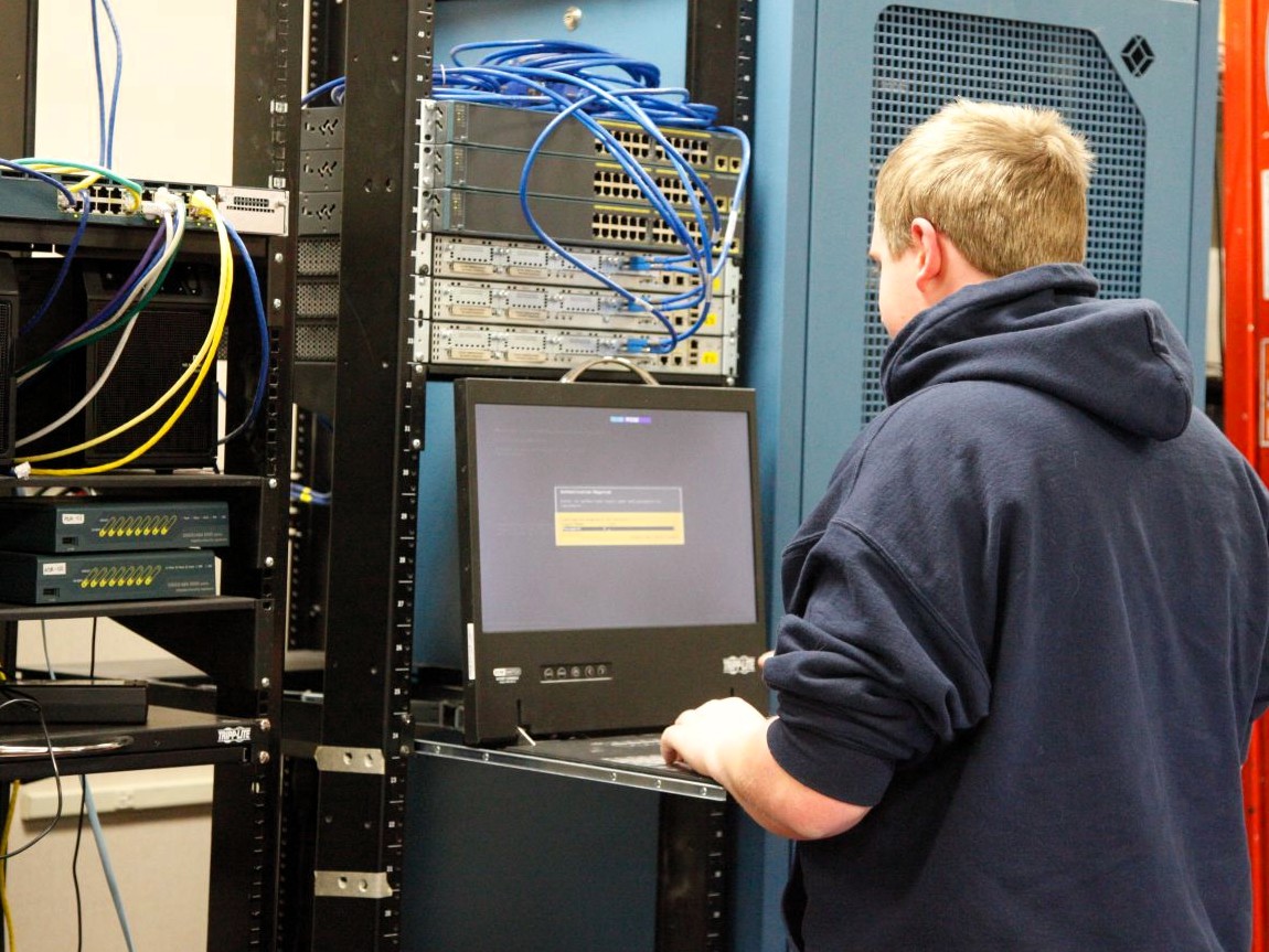 A student is working on the server in the computer support program