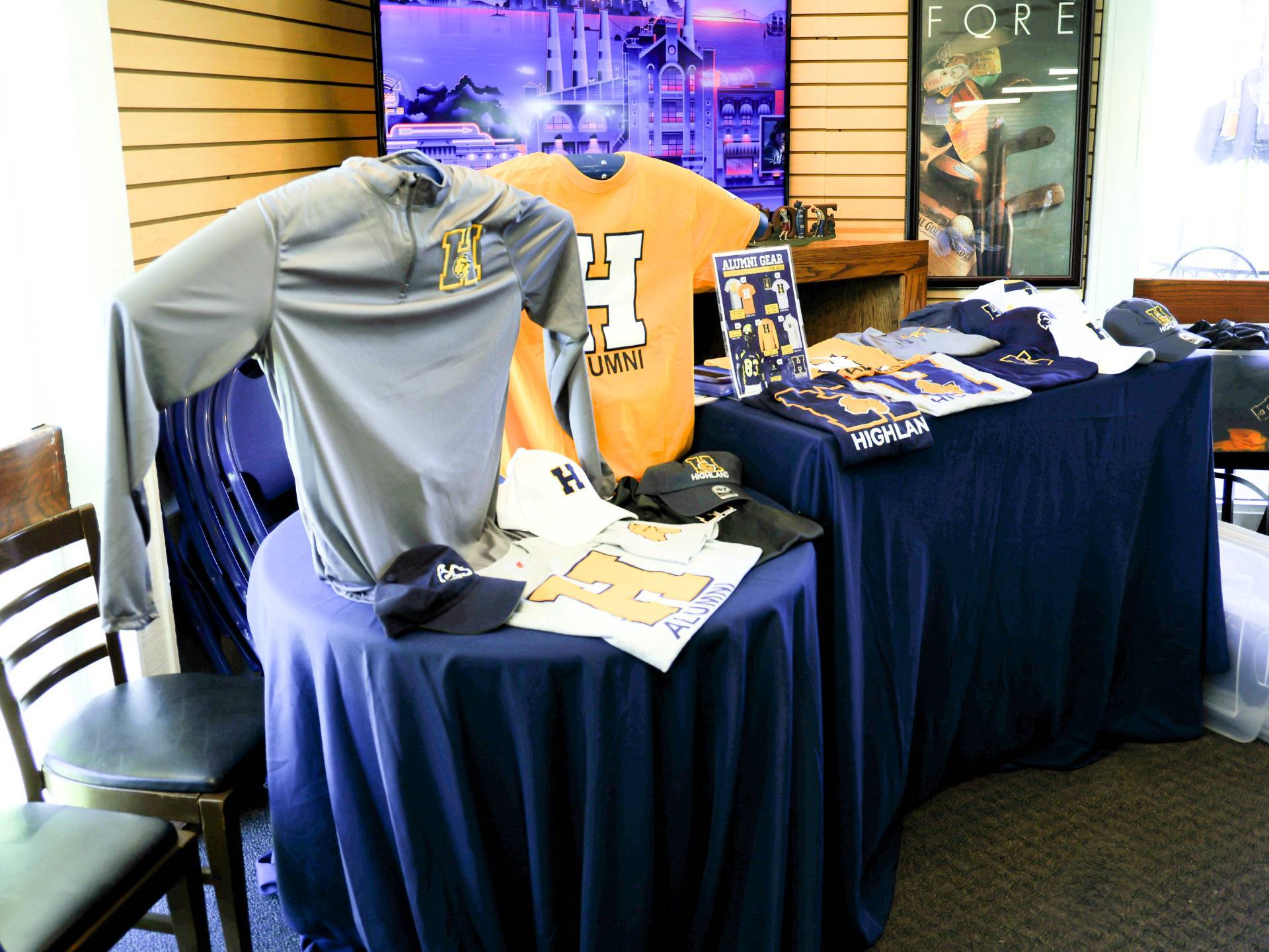 Table with alumni shirts and swag