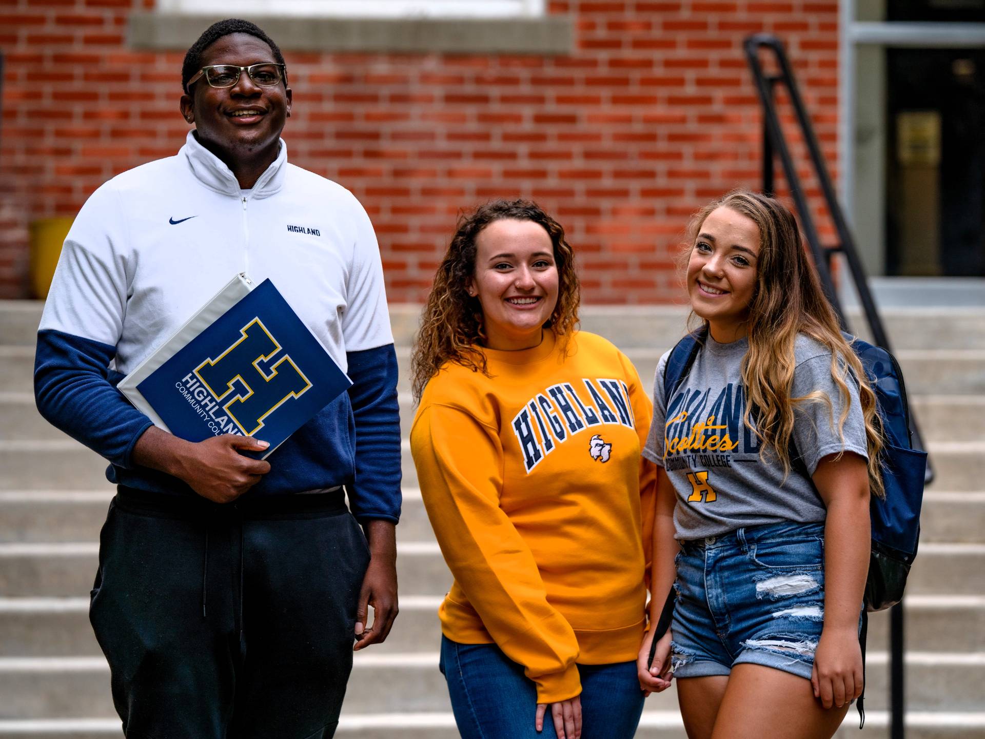 Three students standing outside the Admin Building