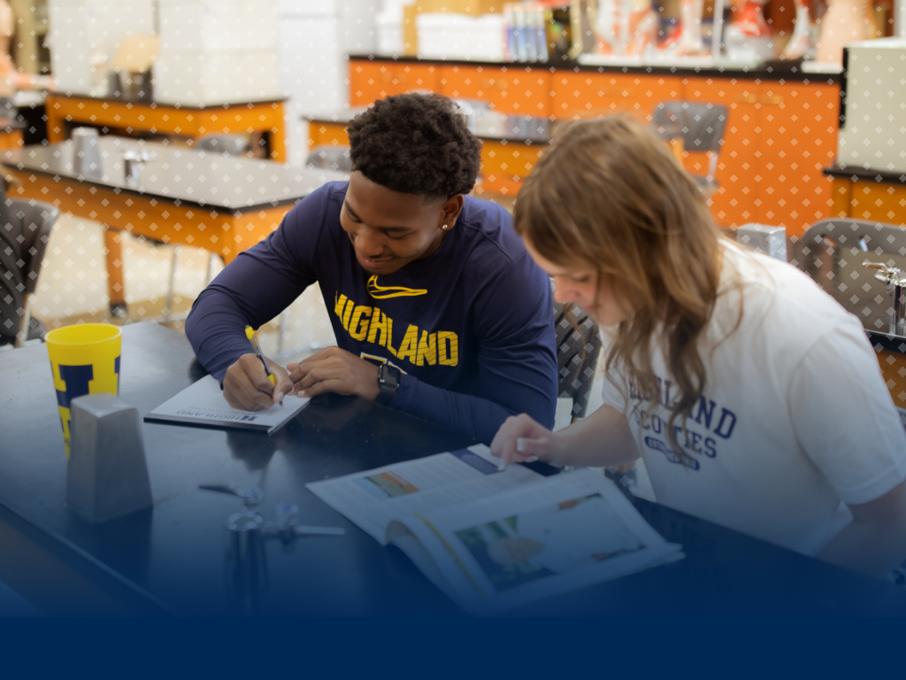 Two students sitting at a table together in a science classroom. Text reads "New Student Enrollment Day"